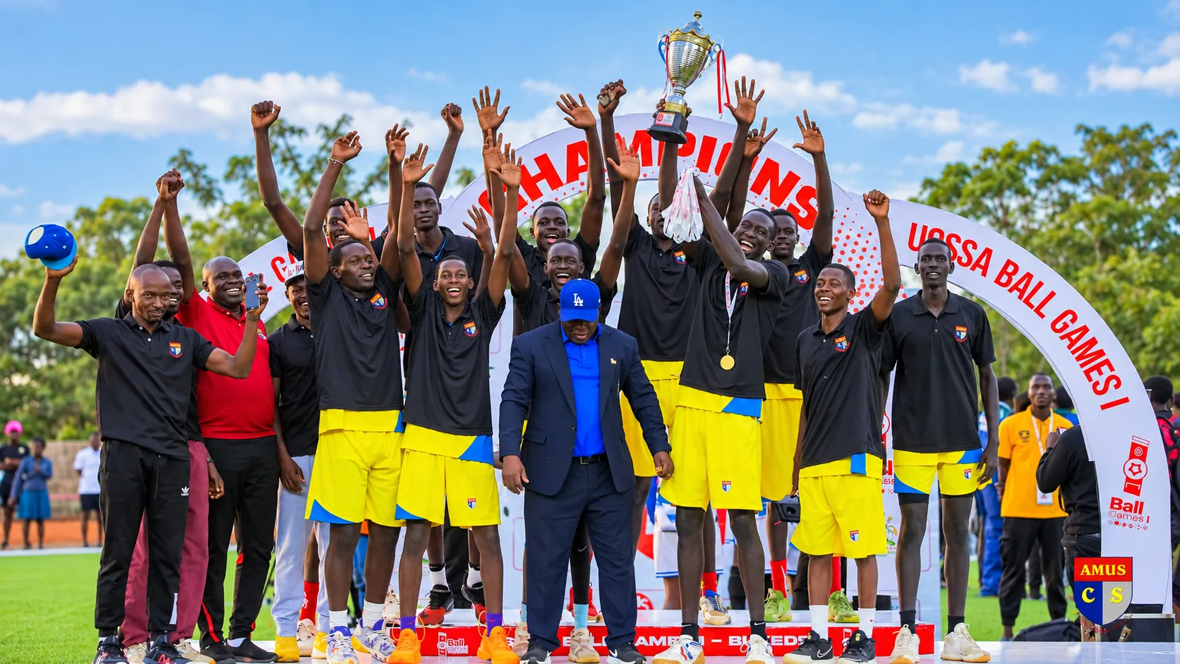 Amus College School players celebrating with a trophy